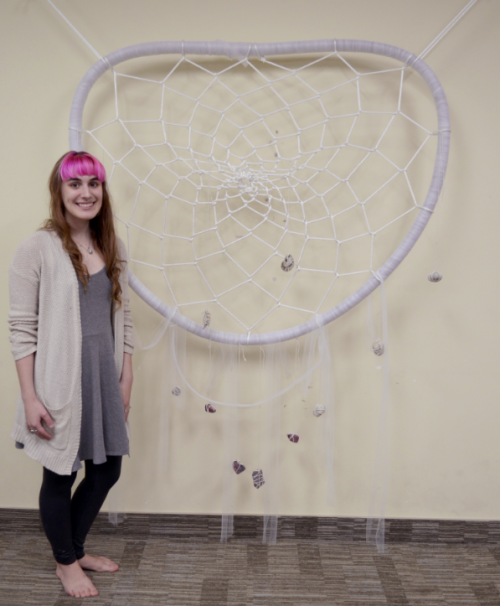Melissa in front of 6 foot tall dream catcher