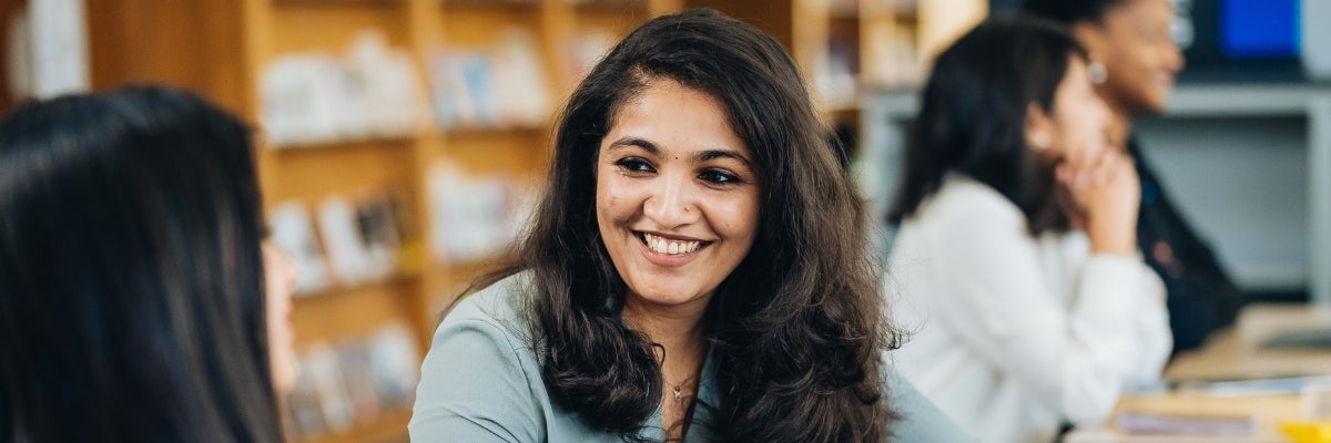 Students chatting in the library