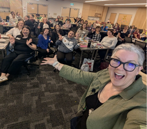 Selfie photo from presenter with attendees in background