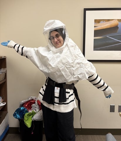 Feyza posing in protective gear looking happy