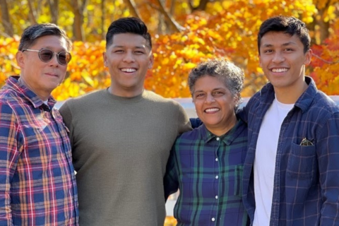 Ruhuni, Barry and family standing in front of fall foilage