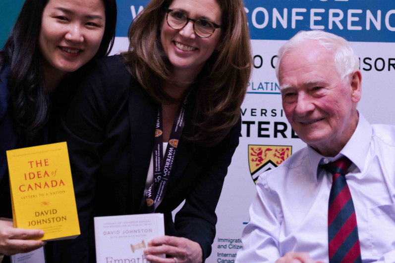 David Johnston and two conference delegates at a book signing