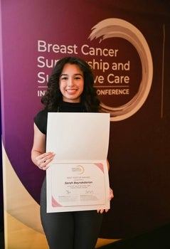 Sarah Bayrakdarian posing with her best poster award