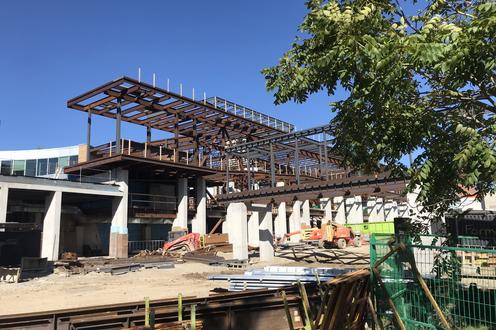 View of the SLC/PAC expansion building as it is constructed showing metal framing and concrete pillars.