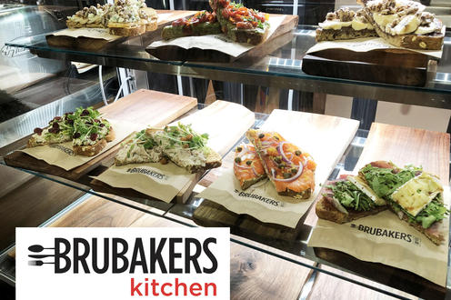 Glass cooler display case with open faced sandwiches and avocado toasts at Brubakers Kitchen