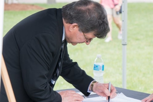 University Architect Dan Parent adds his signature to the expansion project.