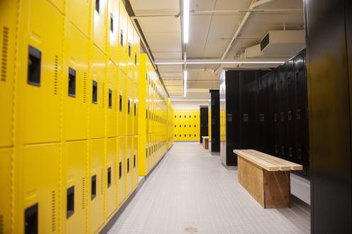 Bright yellow and black lockers along the left wall of the new men's change room in the Physical Activities Complex.