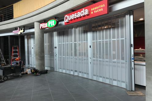 Signage for new dining options in SLC: Shwarma Hub, Pita Pit, and Quesada