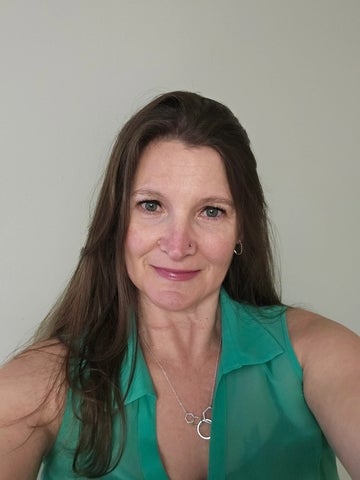 Headshot of a women with brown hair smiling 