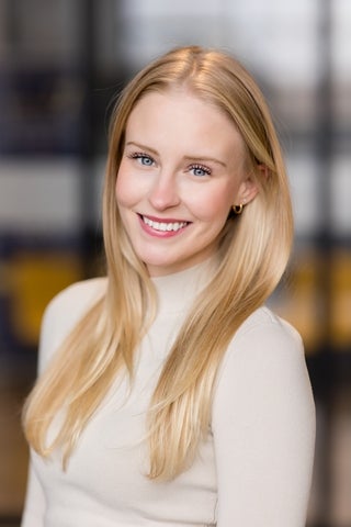 professional headshot of woman with blonde hair and blue eyes.