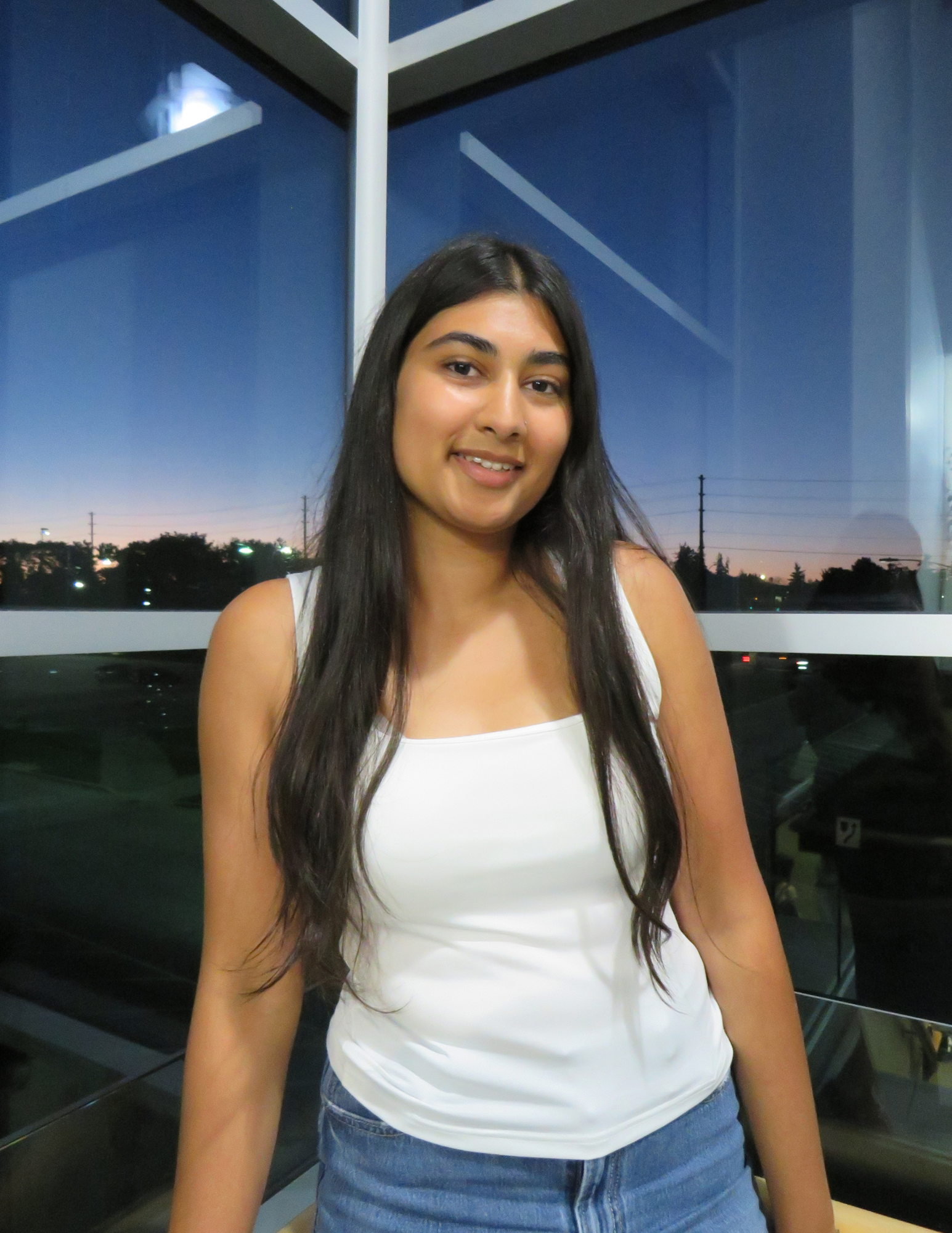 Anusha posing in front of a window