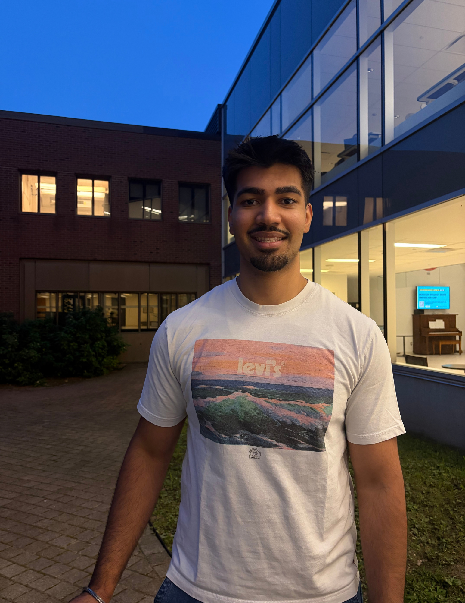 Avi smiling outside