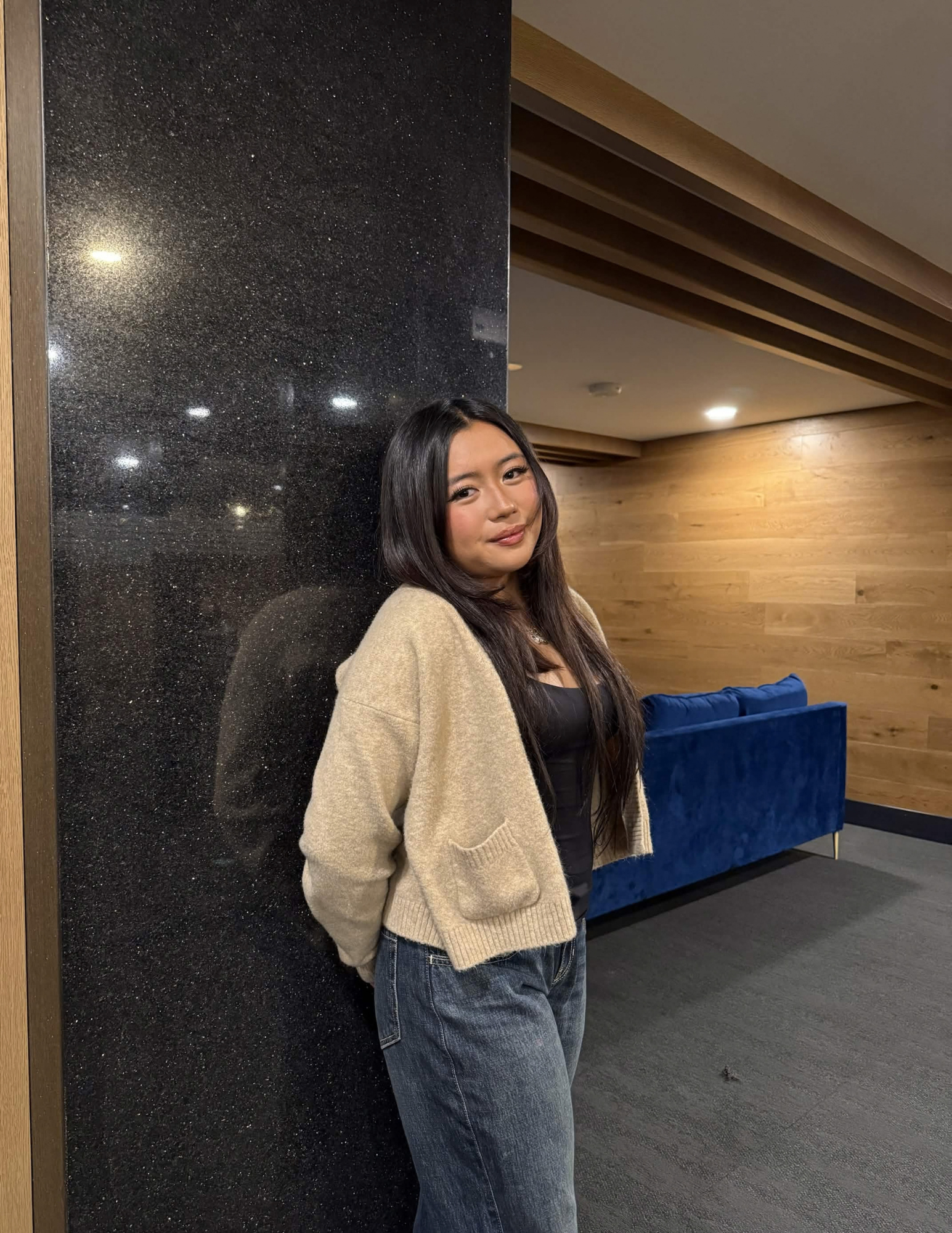 Jenna leaning against a wall