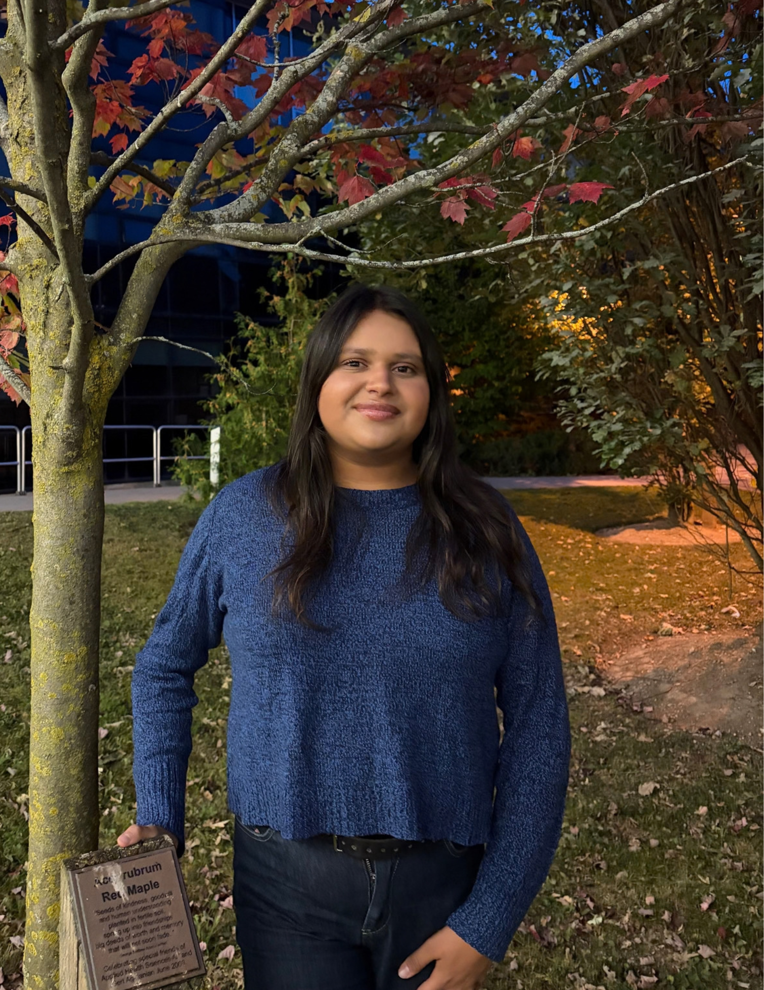 Kimberly posing under a tree