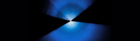 Two fans of blue and white dots extending up and down from center on a black background