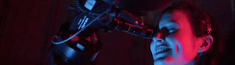 Woman looking through a telescope