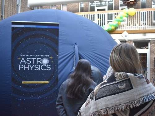 Photo of people walking into the Astro-Bubble planetarium
