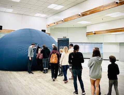 Line of people waiting to enter the Astro-Bubble planetarium