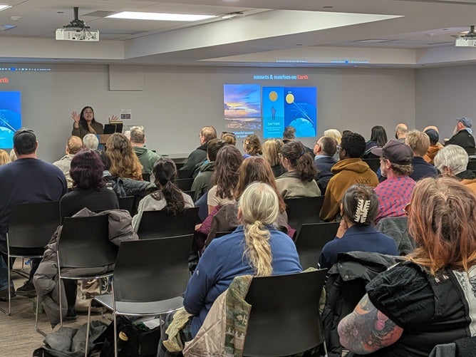 Dr Lisa Dang speaking to a crowd at Kitchener Public Library