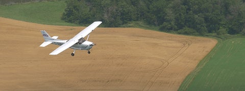 Plane flying over a farm