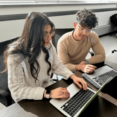 Kritika Grover and Murto Hill working on their laptops together