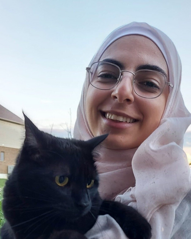 nooran abu mazen holding a black cat