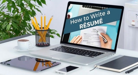 Laptop on desk with how to write a resume on the screen.