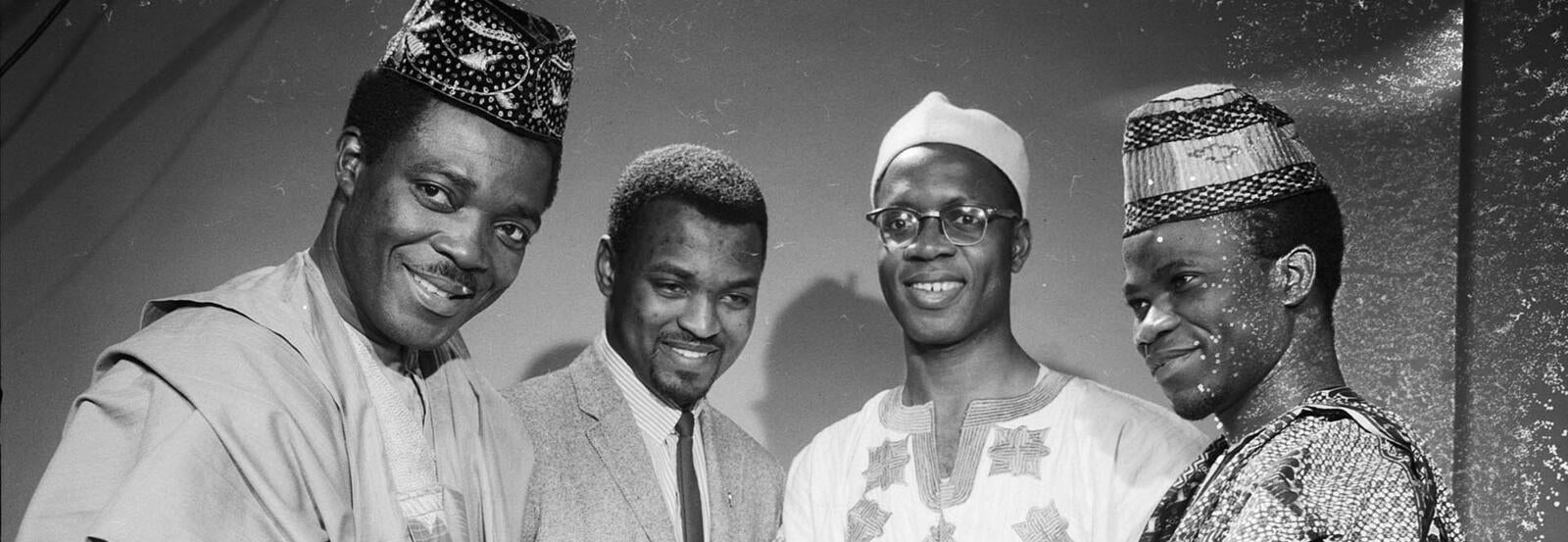 An archival photo of four Black students from Africa in cultural dress