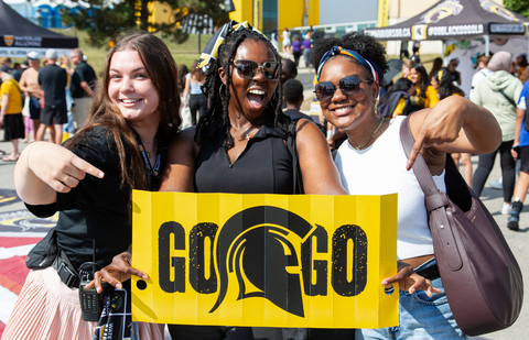 students holding a waterloo warriors poster