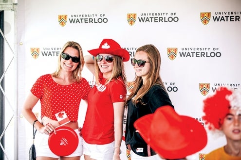 Three women pose for a photo in front of a Waterloo branded backdrop.