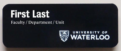 Black name badge with white lettering.