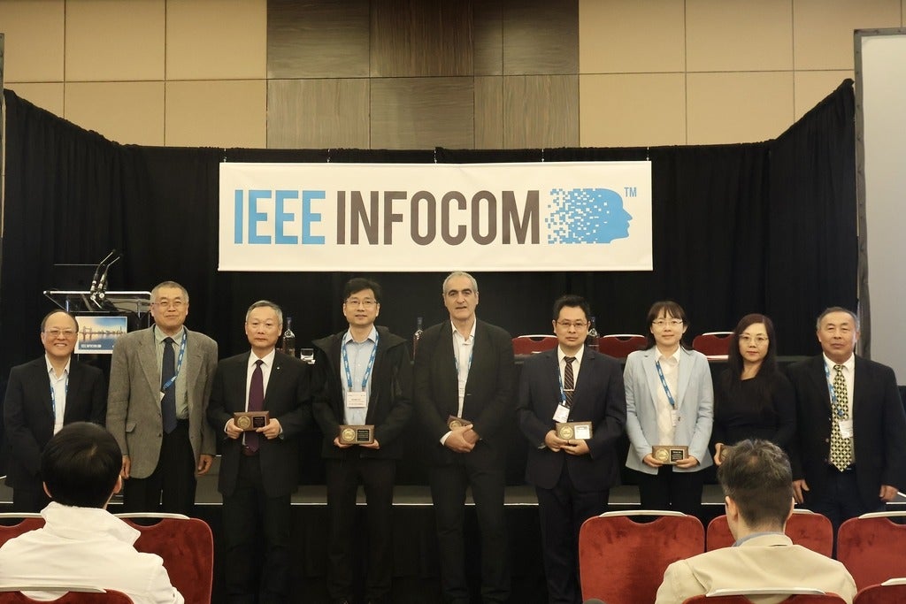 Group photo of newly elevated IEEE Fellows and Prof. Shen in IEEE INFOCOM 2025