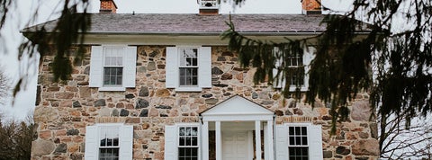 a front view of the filed stone house, that is brubacher house