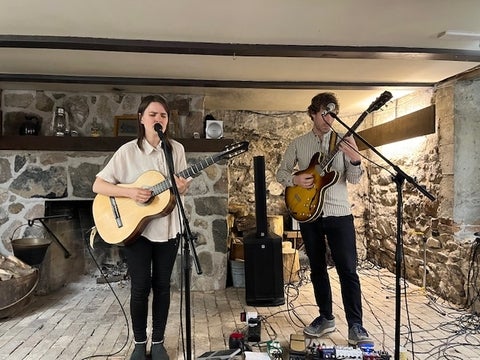 Folk musicians Mirja Klippel and Alex Jonsson performing at a Home Routes concert at Brubacher House