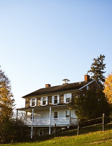 a view of brubacher house at sunset in the fall, with a faint blue sky in the background. 