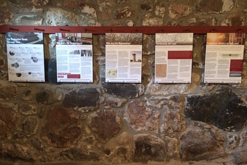 Five information panels hang in the Brubacher House basement.