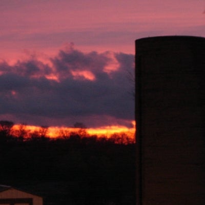 Silo with bright pink and orange sunset