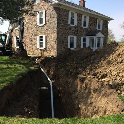 A pit with a sanitation line connected to Brubacher House