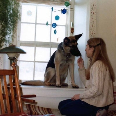 Nancy with her dog (a german shepherd) in the living room of the apartment, 1981.