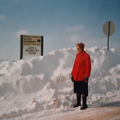 Dorothy stands beside a snow drift, near a university of waterloo sign.