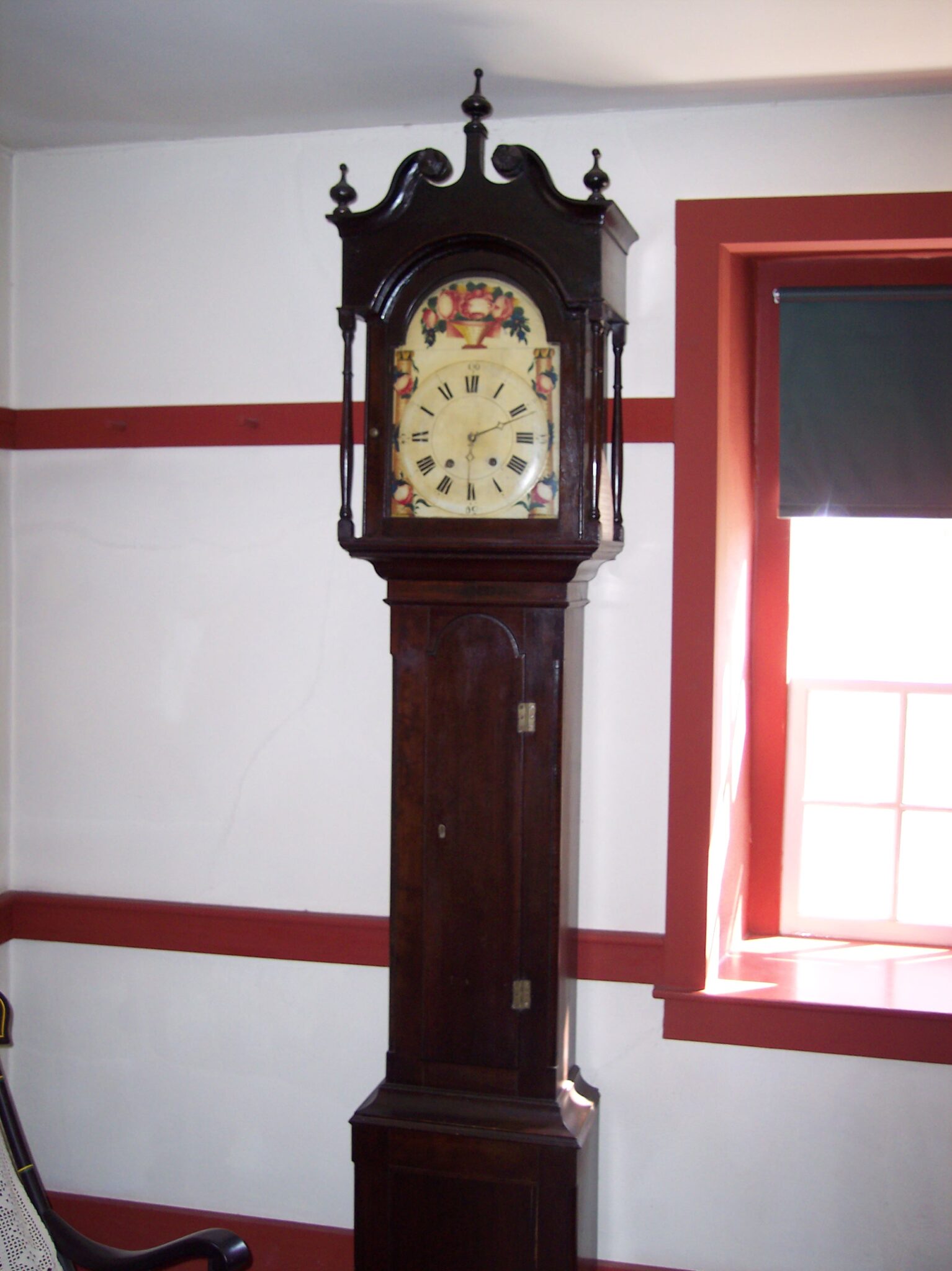 A tall, wooden, ornate grandfather clock