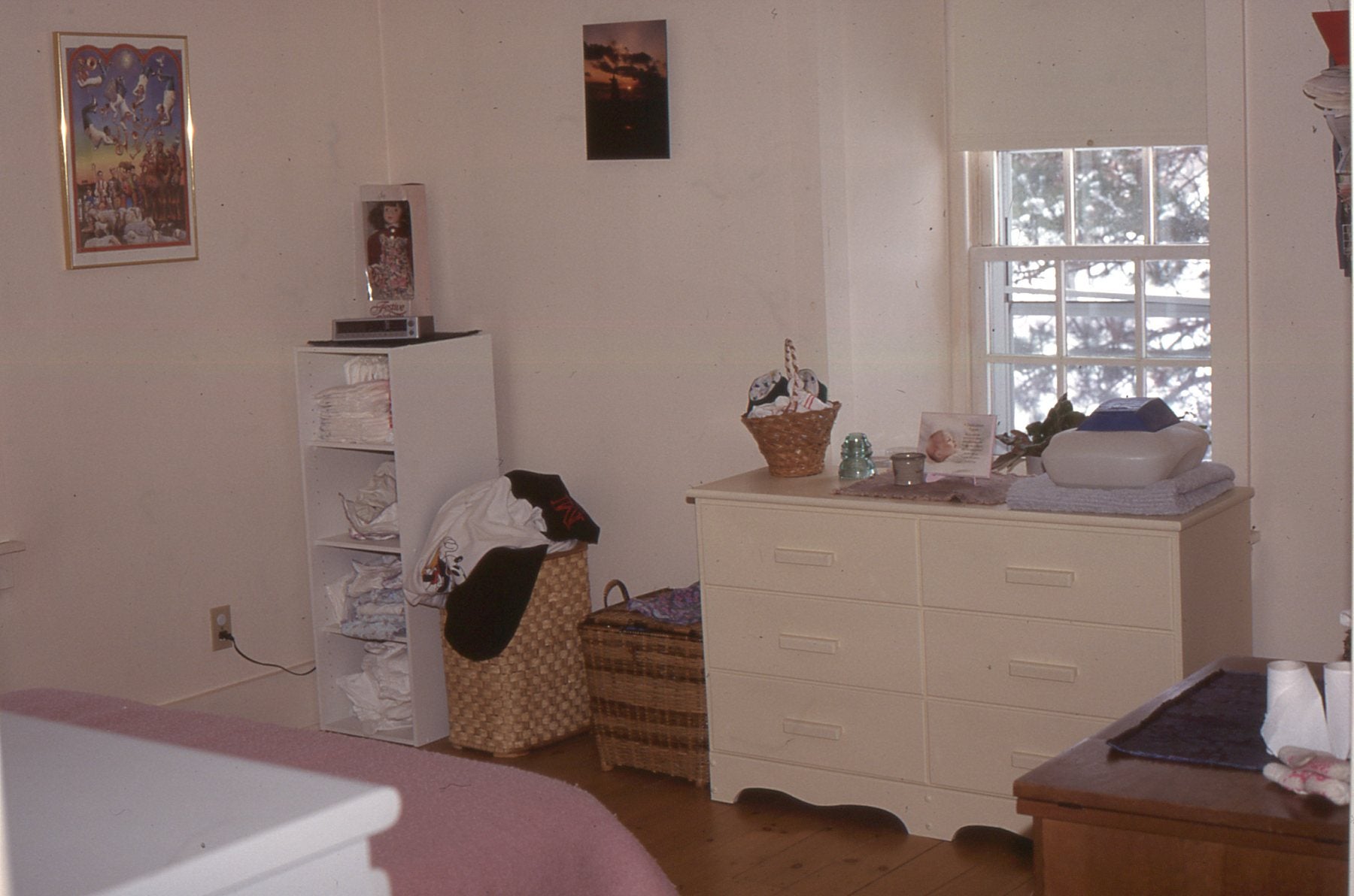 The side wall of a white bedroom with a window, and white dresser