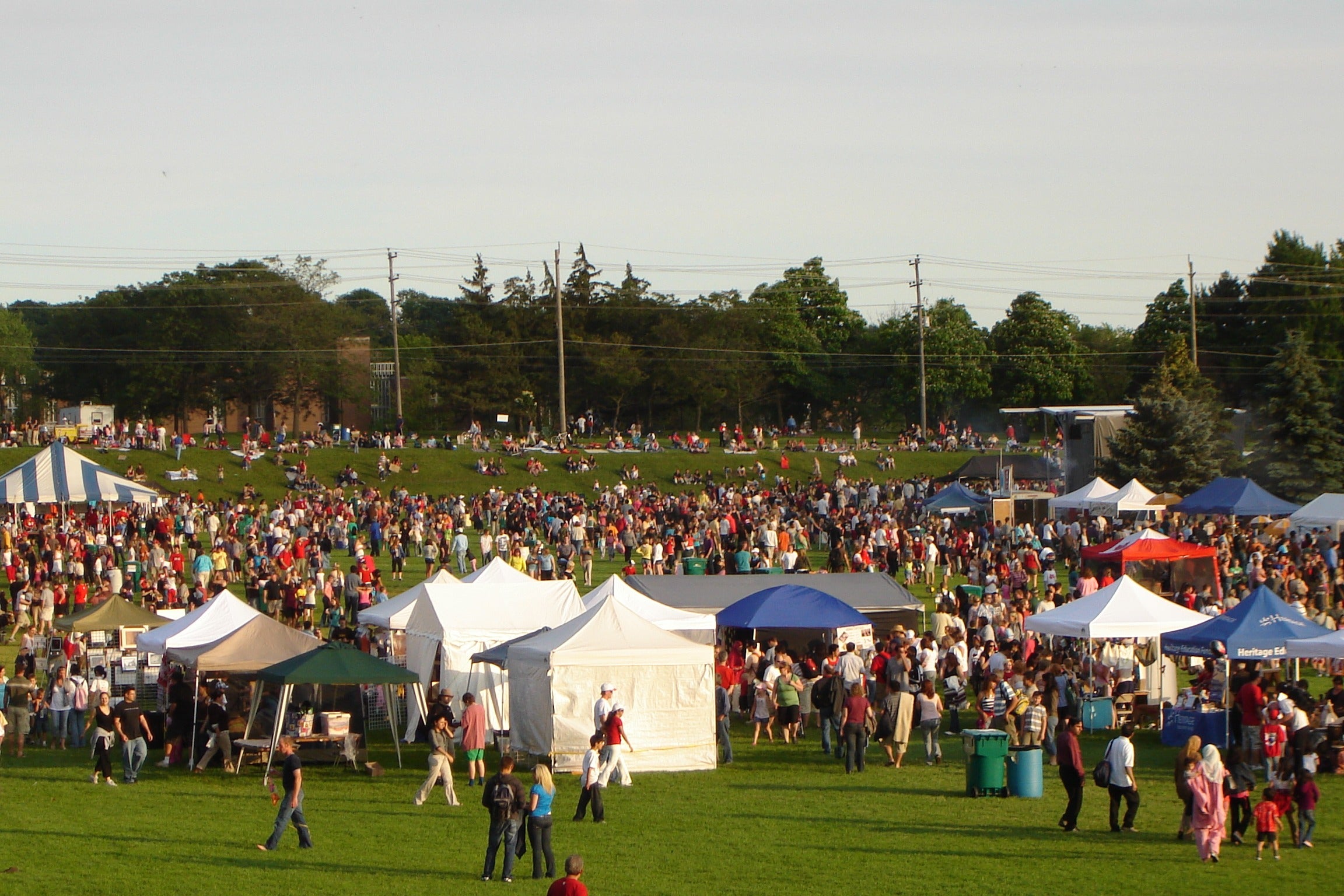 A large crowd gatherings on the Colombia Lake fields, where various tents are set up for Canada Day.