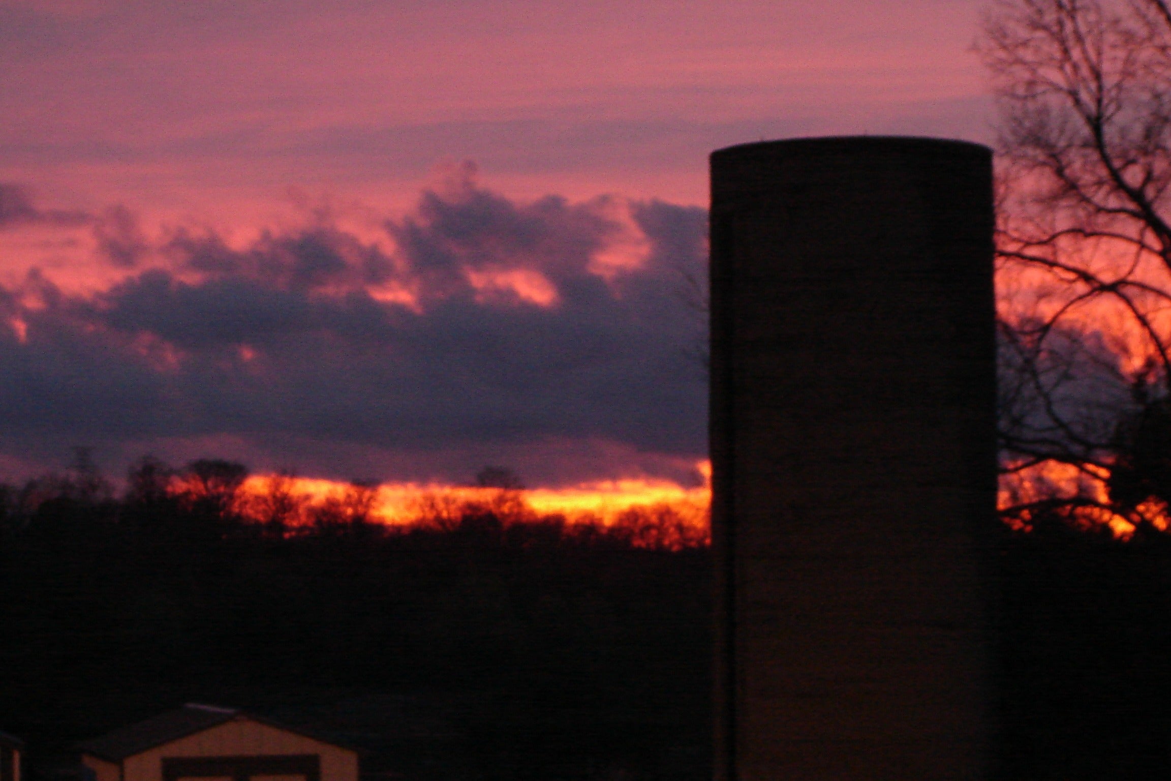 Silo with bright pink and orange sunset