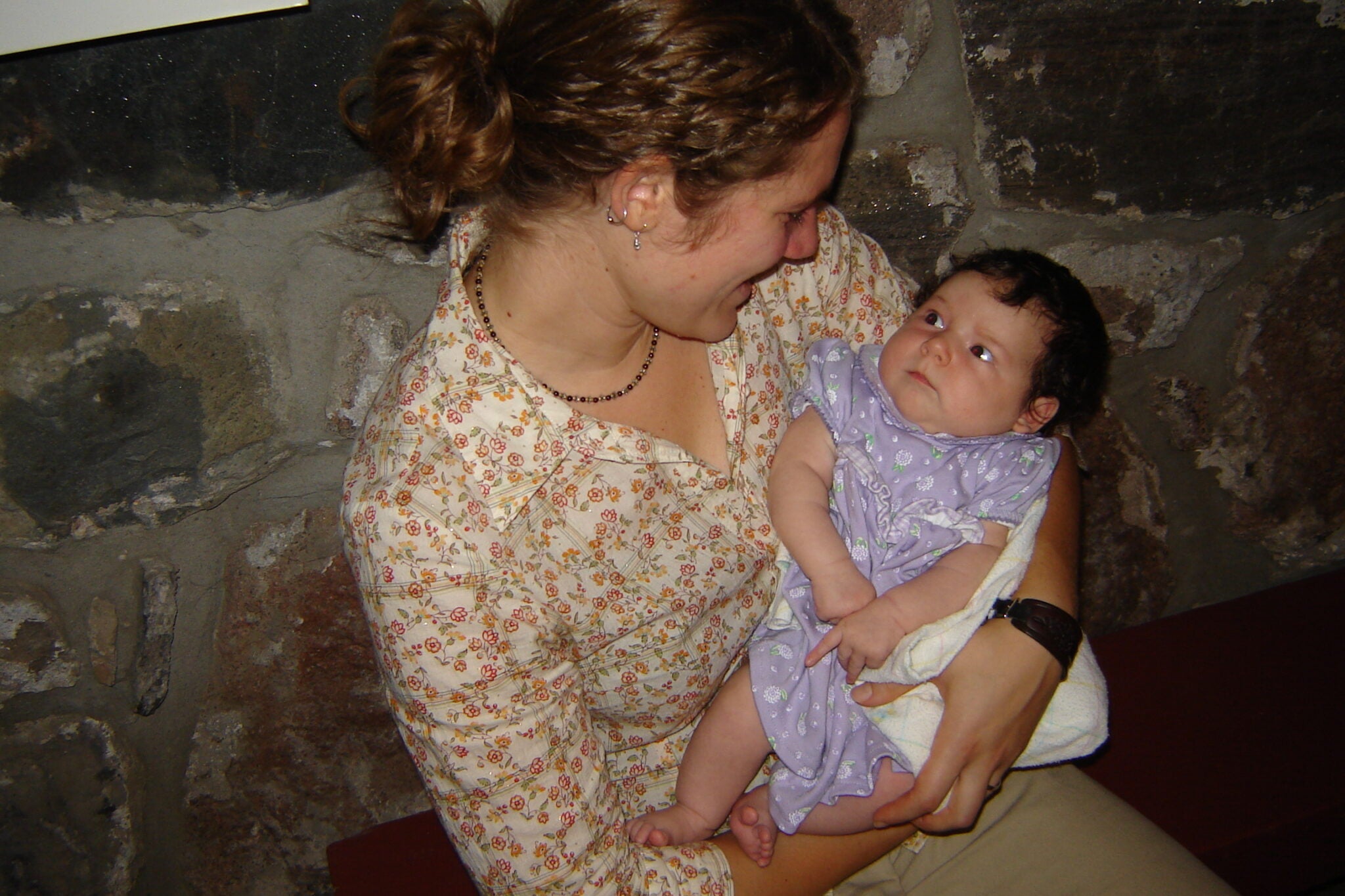 Bethany holds a young baby in Brubacher House