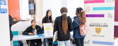 Two students helping a student and their supporter.