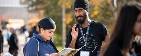 Residence ambassador directing student with map.