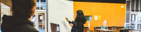 student in front of whiteboard