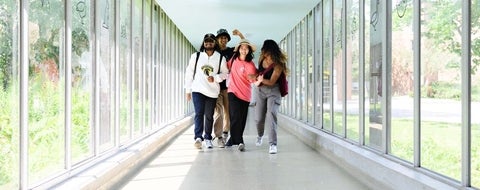 4 students, 2 male and 2 female, walking in the REV tunnel