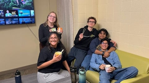 Students sitting around having a treat.